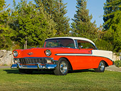 AUT 21 RK2299 01
1956 Chevrolet Bel Air Hardtop Red And Beige 3/4 Front View On Grass By Trees