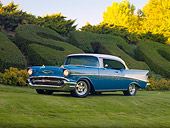 AUT 21 RK2300 01
1957 Chevrolet Bel Air Hardtop Blue And White 3/4 Front View On Grass By Hedge