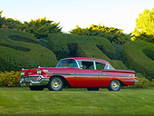 AUT 21 RK2302 01
1958 Chevrolet Bel Air Hardtop Red 3/4 Front View On Grass By Hedge