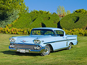 AUT 21 RK2304 01
1958 Chevrolet Impala Hardtop Light Blue 3/4 Front View On Grass By Hedge