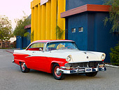 AUT 21 RK2340 01
1956 Ford Customline Victoria Red And White 3/4 Front View On Pavement By Building