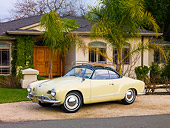 AUT 21 RK2353 01
1958 Volkswagen Karmann Ghia Beige 3/4 Front View On Gravel By House