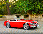 AUT 22 BK0012 01
1960 Austin-Healey 3000 BT7 Roadster Red 3/4 Front View On Pavement By Trees