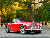 AUT 22 BK0013 01
1960 Austin-Healey 3000 BT7 Roadster Red 3/4 Front View On Pavement By Trees