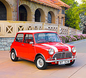 AUT 22 BK0022 01
1961 Mini Mark I Red With White Stripes 3/4 Front View On Pavement By Building