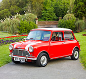 AUT 22 BK0025 01
1961 Mini Mark I Red With White Stripes 3/4 Front View On Pavement By Garden