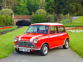 AUT 22 BK0026 01
1961 Mini Mark I Red With White Stripes 3/4 Front View On Pavement By Garden