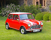 AUT 22 BK0028 01
1961 Mini Mark I Red With White Stripes 3/4 Front View On Grass By Building