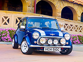 AUT 22 BK0030 01
1965 Mini Blue With Silver Stripes 3/4 Front View On Pavement By Building