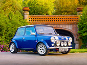 AUT 22 BK0032 01
1965 Mini Blue With Silver Stripes 3/4 Front View On Pavement By Bridge