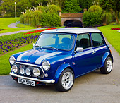 AUT 22 BK0034 01
1965 Mini Blue With Silver Stripes 3/4 Front View On Pavement By Garden