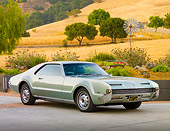 AUT 22 BK0043 01
1966 Oldsmobile Toronado Green Silver 3/4 Front View On Pavement By Hills