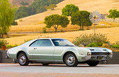 AUT 22 BK0044 01
1966 Oldsmobile Toronado Green Silver 3/4 Front View On Pavement By Hills
