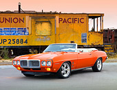 AUT 22 BK0053 01
1969 Pontiac Firebird Convertible Orange 3/4 Front View On Pavement By Train