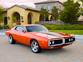 AUT 22 BK0079 01
1973 Dodge Charger 440 Magnum R/T Orange With Black Stripe 3/4 Front View On Pavement By House