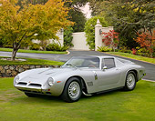 AUT 22 BK0088 01
1965 Bizzarrini 5300 GT Strada Silver 3/4 Front View On Grass By House And Autumn Trees