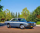 AUT 22 RK1506 01
1969 Plymouth Barracuda 340 Blue White Stripe 3/4 Side View On Pavement By Trees Blue Sky