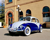 AUT 22 RK1689 02
1967 VW Beetle Two Tone Blue Low 3/4 Front View On Pavement By Building