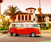 AUT 22 RK1782 01
1967 Volkswagen Bus Deluxe Orange And White 3/4 Front View By Spanish Building And Trees