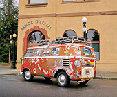 AUT 22 RK1924 01
1961 VW Bus Ragtop Rusty With Stickers 3/4 Rear View On Pavement By Building
