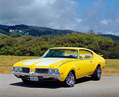 AUT 22 RK2140 02
1969 Oldsmobile 442 Yellow White Stripe Low 3/4 Front View On Pavement