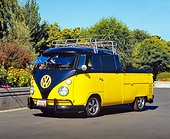 AUT 22 RK2188 03
1963 Volkswagen Crewcab Black And Yellow 3/4 Front View On Pavement By Flowers And Trees