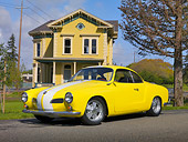 AUT 22 RK2467 01
1961 Volkswagen Karmann Ghia Yellow And White 3/4 Side View On Pavement