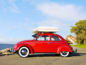 AUT 22 RK2837 01
1964 Volkwagen Beetle Red With Topper Tent Profile View On Pavement By Ocean