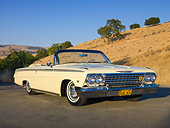 AUT 22 RK2891 01
1962 Chevrolet Impala Convertible Yellow 3/4 Front View On Pavement By Hills