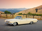AUT 22 RK2893 01
1962 Chevrolet Impala Convertible Yellow 3/4 Front View On Pavement By Hills