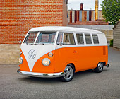 AUT 22 RK3002 01
1965 Volkswagen Kombi Microbus Orange And White 3/4 Front View On Pavement By Brick Wall