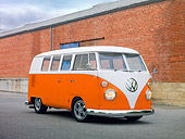 AUT 22 RK3004 01
1965 Volkswagen Kombi Microbus Orange And White 3/4 Front View On Pavement By Brick Wall