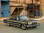 AUT 22 RK3088 01
1967 Plymouth Hemi GTX Dark Green 3/4 Front View On Pavement By Old Factory Building