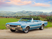 AUT 22 RK3171 01
1966 Oldsmobile 442 Light Blue 3/4 Front View On Gravel By Grass Field And Hills