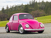 AUT 22 RK3198 01
1967 Volkswagen Bug Bright Pink 3/4 Front View On Gravel By Grass And Pine Trees