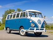 AUT 22 RK3240 01
1965 VW 21 Window Deluxe Sea Blue And White 3/4 Front View On Pavement By Trees
