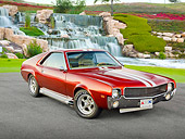 AUT 22 RK3298 01
1969 AMC AMX Candy Tangerine With White Stripes 3/4 Front View On Pavement By Waterfalls