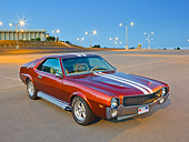 AUT 22 RK3305 01
1969 AMC AMX Candy Tangerine With White Stripes 3/4 Front View In Parking Lot At Dusk