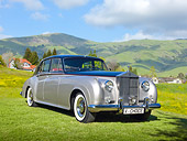 AUT 22 RK3328 01
1960 Rolls-Royce Silver Cloud II Radford Countryman Black And Silver 3/4 Front View On Grass By Hills
