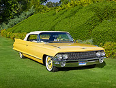 AUT 22 RK3331 01
1961 Cadillac Series 62 Maize Yellow 3/4 Front View On Grass By Shrubs