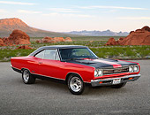 AUT 22 RK3446 01
1969 Plymouth GTX Red With Black Stripes 3/4 Front View On Pavement In Desert