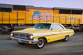 AUT 22 RK3448 01
1964 Ford Galaxie 500 XL Factory Lightweight Banana Yellow Pearl 3/4 Front View On Pavement By Train