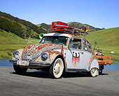 AUT 22 RK3459 01
1969 Volkswagen Beetle White And Rusty 3/4 Front View On Pavement By Water And Grassy Hills