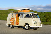AUT 22 RK3463 01
1966 Volkswagen Camper Cream 3/4 Side View On Pavement By Grassy Hills