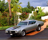 AUT 22 RK0137 03
1969 Oldsmobile 442 Silver Front 3/4 View By Plants And Trees