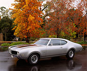AUT 22 RK0140 05
1969 Oldsmobile 442 Silver  3/4 Front View On Pavement By Fall Trees