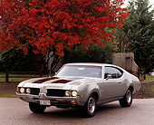 AUT 22 RK0142 02
1969 Oldsmobile 442 Silver And Black 3/4 Front View On Pavement By Fall Trees