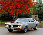AUT 22 RK0142 07
1969 Oldsmobile 442 Silver And Black 3/4 Front View On Pavement By Fall Trees