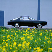 AUT 22 RK0170 06
1965 Alfa Romeo Giulietta SS, profile on pavement with building in background and field of flowers in foreground