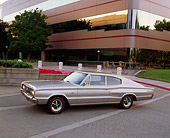 AUT 22 RK0192 06
1966 Dodge Charger 426 Hemi Silver 3/4 Front View On Pavement In Front Of Building Headlights On